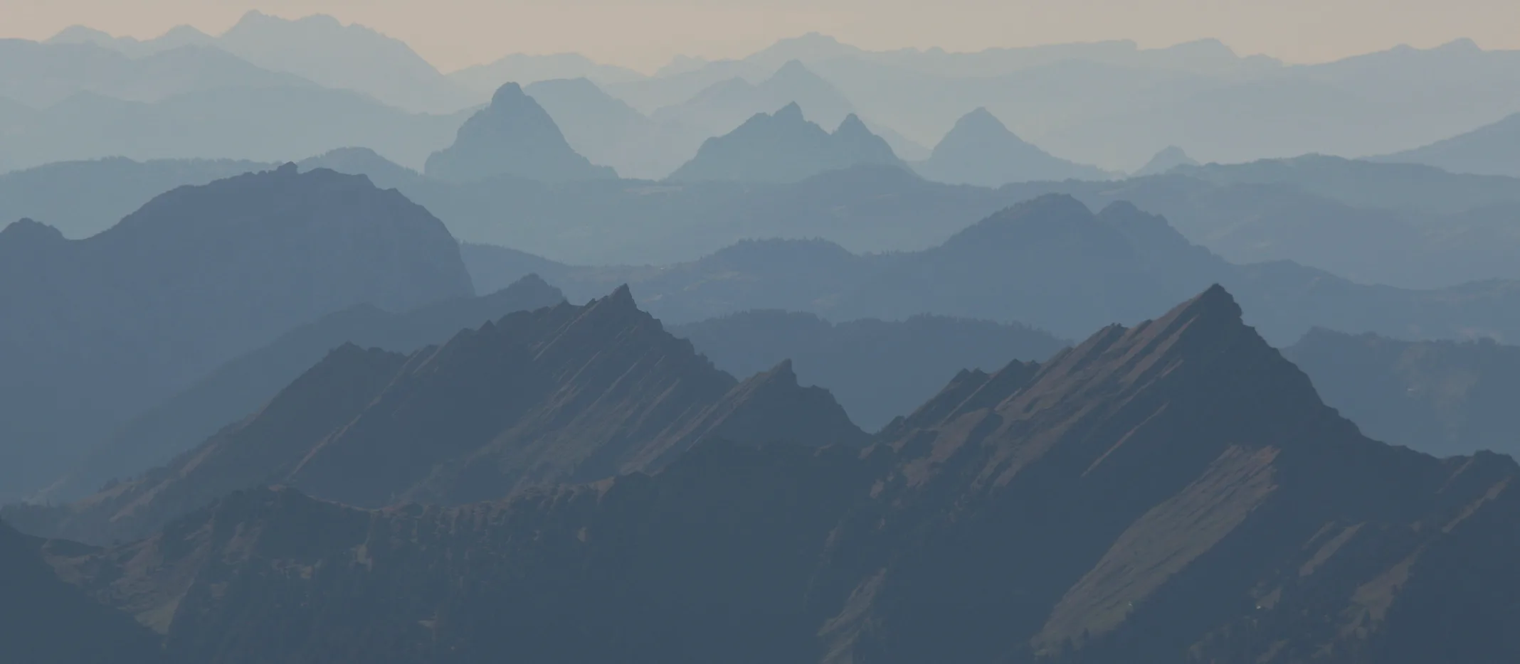 Layered mountain ridgelines fading into haze