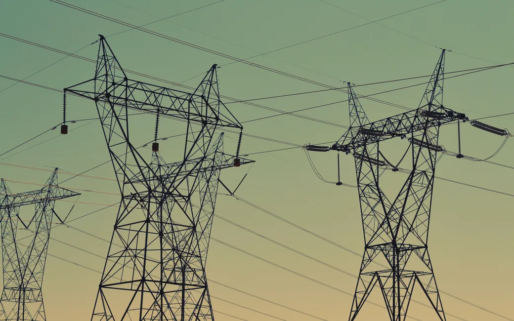 Electricity transmission pylons and lines across open ground