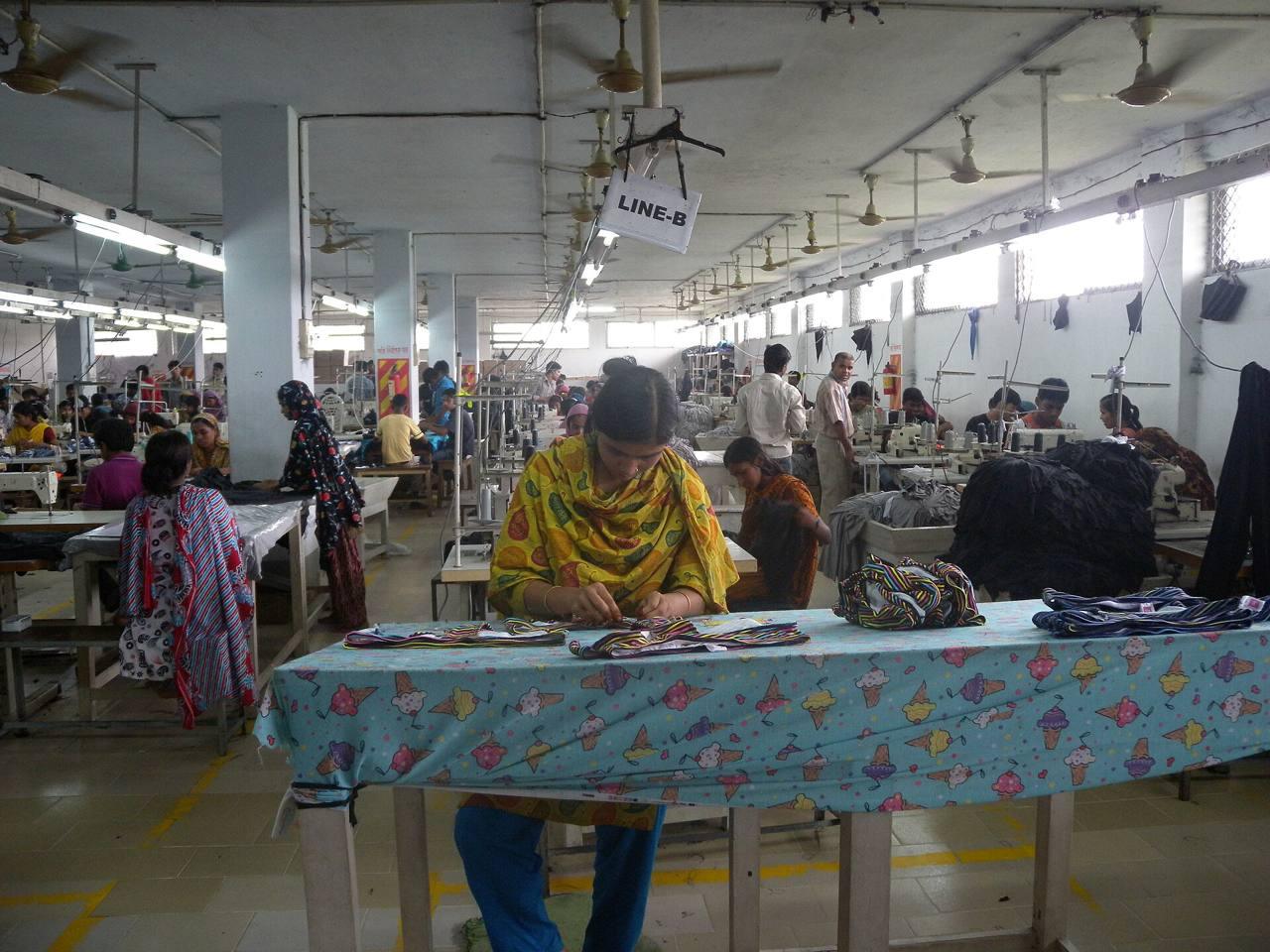 Rows of sewing stations on a garment factory floor